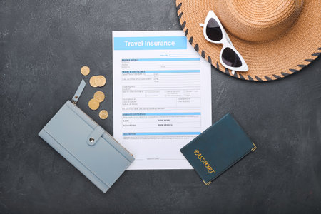 Composition with travel insurance and passport on dark backgroundの写真素材