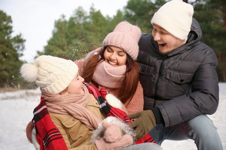Happy family in park on winter dayの写真素材