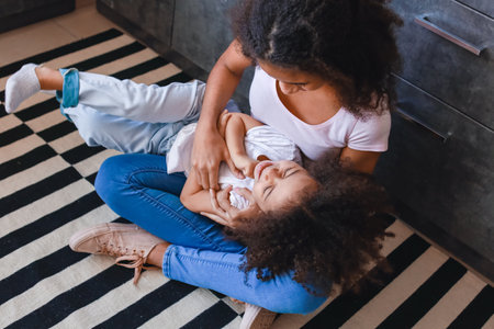 Cute African-American sisters at homeの写真素材