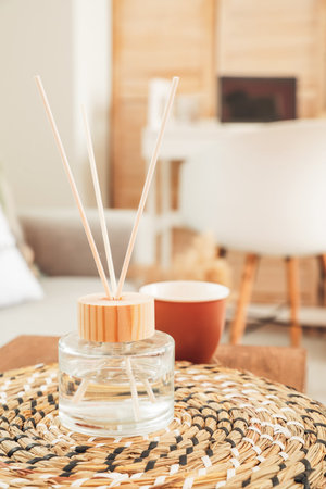 Reed diffuser on ottoman in room