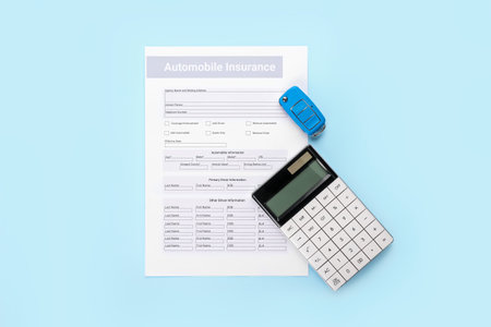 Automobile insurance with car key and calculator on color backgroundの写真素材