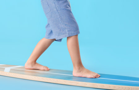 Cute little boy with surfboard on color backgroundの写真素材