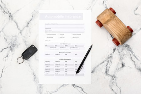 Automobile insurance with key and car figure on light backgroundの写真素材