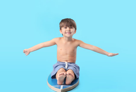 Cute little boy with surfboard on color backgroundの写真素材