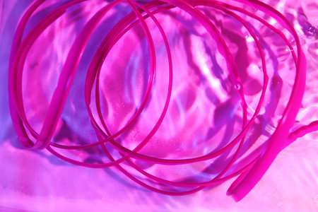 Plastic spiral in water on color background