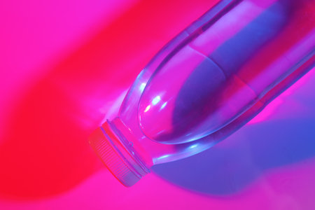 bottle of water on neon color backgroundの写真素材