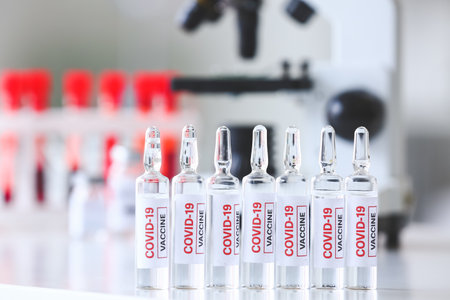 Samples of vaccine against COVID-19 on table in laboratoryの写真素材
