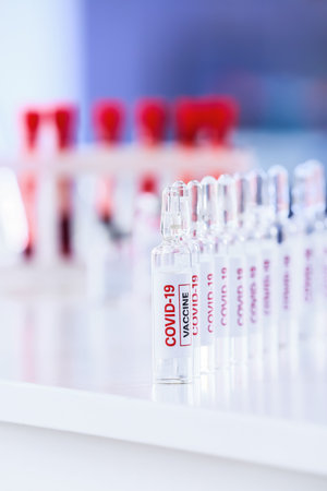 Samples of vaccine against COVID-19 on table in laboratoryの写真素材