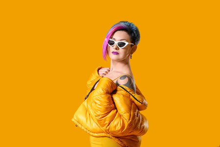 Portrait of extravagant stylish woman on color background
