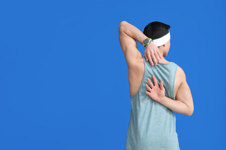 Sporty male coach on color background