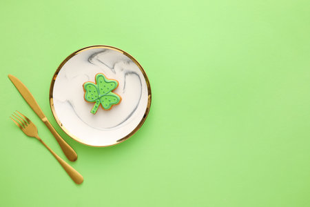 Beautiful table setting for St. Patrick's Day celebration on color backgroundの写真素材