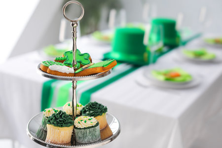 Dessert stand with tasty treats for St. Patrick's Day celebration in dining room