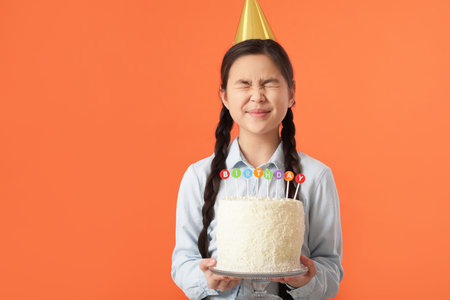 Cute little girl with birthday cake on color background