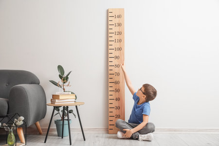 little boy measuring height at home