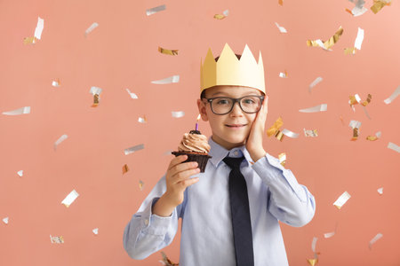 Cute little boy celebrating Birthday on color backgroundの写真素材