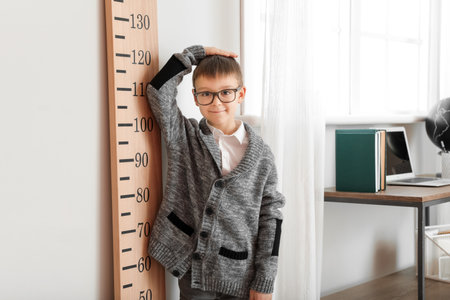 little boy measuring height at homeの写真素材