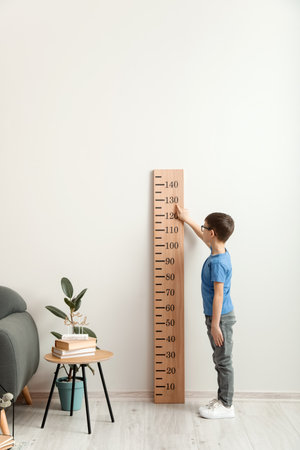 little boy measuring height at homeの写真素材