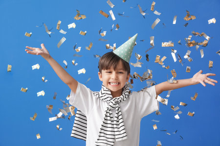 Cute little boy celebrating Birthday on color background