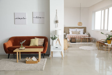 Stylish interior of room with comfortable sofa and table