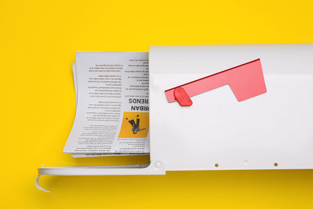 Mail box with newspapers on color backgroundの写真素材