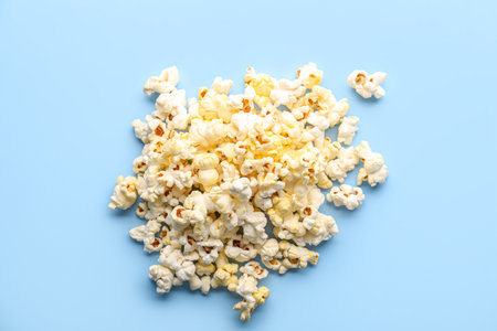 Heap of tasty popcorn on color backgroundの写真素材