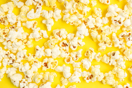 Tasty popcorn on yellow background, closeupの写真素材