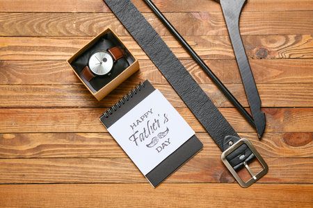 Composition for Father's Day with notebook, greeting card and accessories on wooden backgroundの写真素材
