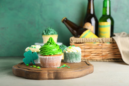 Tasty cupcakes for St. Patrick's Day and beer on tableの写真素材
