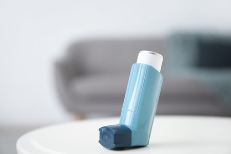 Modern inhaler on table at home, closeupの写真素材