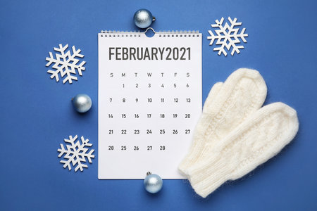 Calendar with Christmas decor on color backgroundの写真素材