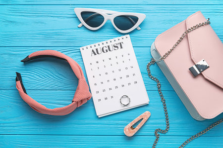 Calendar with female accessories on color wooden backgroundの写真素材