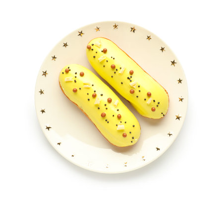 Plate with delicious glazed eclairs isolated on white background