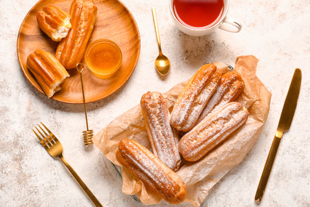 Composition with sweet eclairs and honey on light backgroundの写真素材