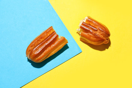 Crushed eclair on color background