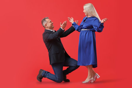 Dancing mature couple on color backgroundの写真素材