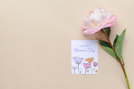Beautiful flower and greeting card for Mother's Day on color backgroundの写真素材