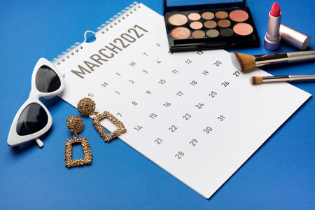 Calendar with female accessories on color background. International Women's Day celebrationの写真素材