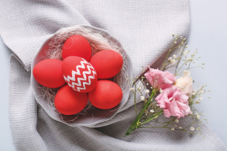 Composition with beautiful Easter eggs on light background