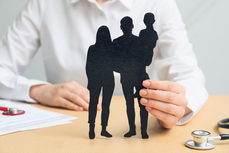 Woman with family figures on color table, closeup. health insurance conceptの写真素材