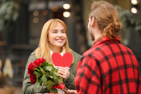 Happy young couple walking in city on Valentine's Dayの写真素材