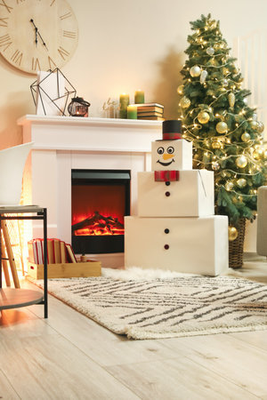 Funny snowman in living room decorated for Christmasの写真素材