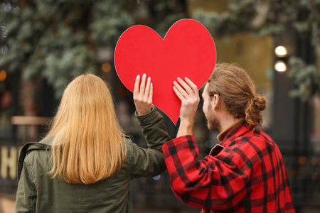 Happy young couple walking in city on Valentine's Dayの写真素材