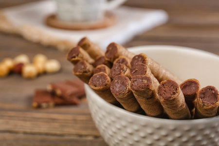 Plate with tasty wafer rolls on table, closeupの写真素材