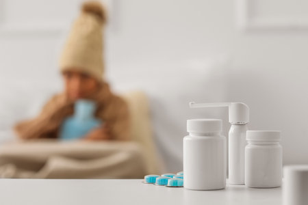 Different medicines on table in bedroom of ill boy, closeupの写真素材