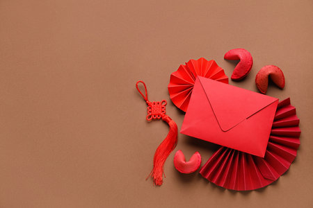 Red envelope with fortune cookies and Chinese symbols on brown background. new year celebrationの写真素材