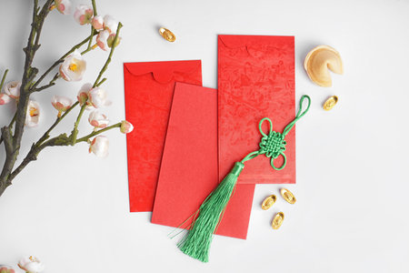 Red envelopes, fortune cookie and Chinese symbols on white backgroundの写真素材