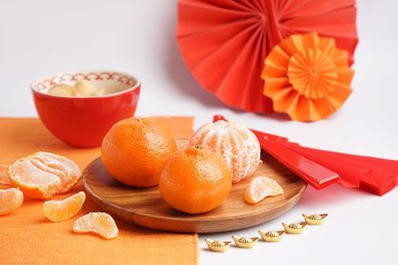 Plate with tangerines and Chinese symbols on color background, closeupの写真素材