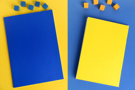 Composition with bright notebooks and cubes on color background
