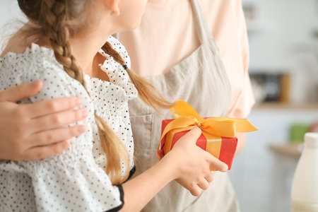 Little girl greeting her mom on Mother's Day at home, closeupの写真素材