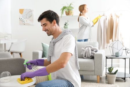 Young couple cleaning their flat